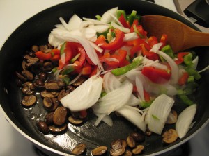 Adding the Peppers and Onions to the Mushrooms